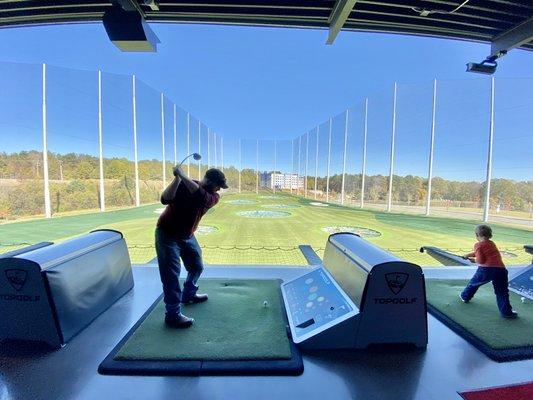 Golf swing training a client at TopGolf