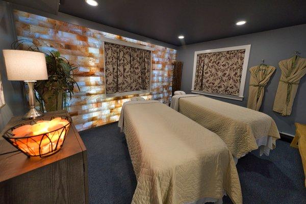 Couple's massage room with full himalayan salt walls and relaxing lighting.