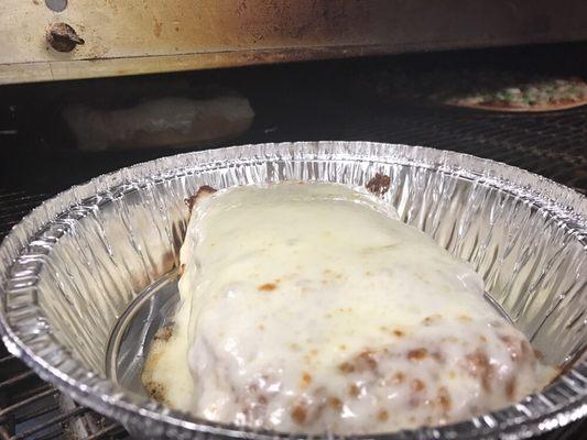 Lasagna rolling out of the oven.