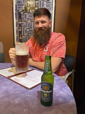 A hottie holding a frosted mug full of beer next to my NA.