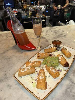 Corn taquitos filled with chicken topped with queso fresco and the Cinderella margarita