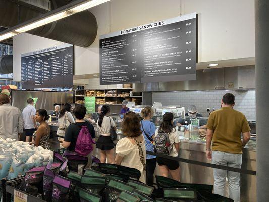 People lined up at the sandwich shop