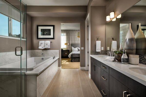 Large primary bathroom oasis with dual sink vanities and large sink-in tubs