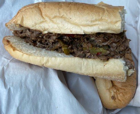 Cheesesteak with hot peppers. Amoroso roll, American cheese .... Horrible chewy meat.