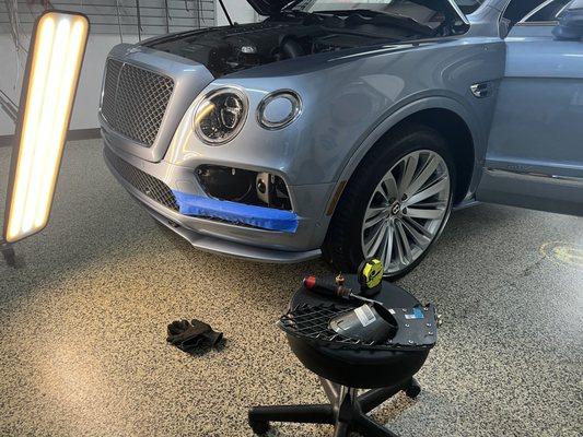 Removed a dent from the front bumper of this 2016 Bentley Bentayga.