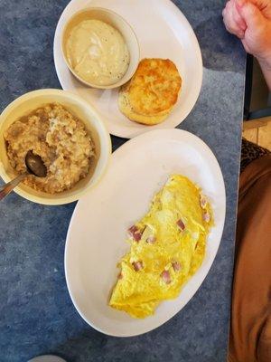 Ham and cheese omelet with oatmeal and biscuits n gravy.