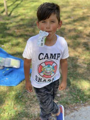 Michael enjoying a popsicle after playing musical chairs.