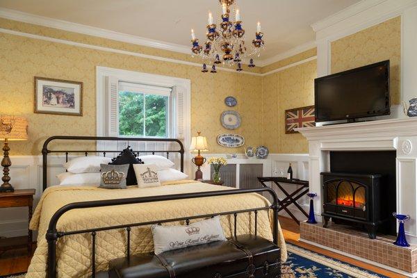 The Harriet room with a king bed and an electric fireplace.