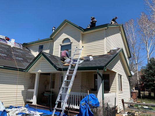 Roofing contractors working on installing a roof