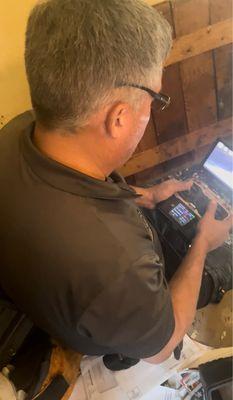 Donn controlling mini cart equipped with camera for underneath foundation/plumbing inspection.