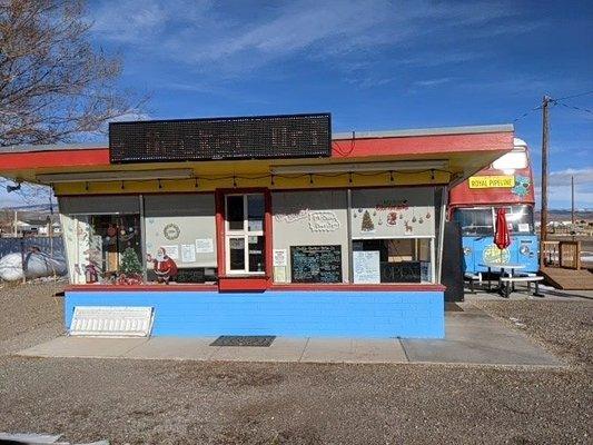 Front of restaurant, facing hwy 24, order at the front window and take your food to go or eat in the Double decker bus.