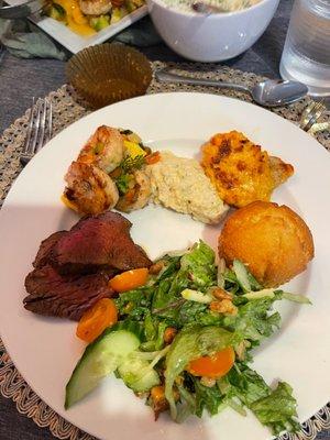 Coastal chic beef tenderloin, grouper, grits, corn bread , salad and shrimp