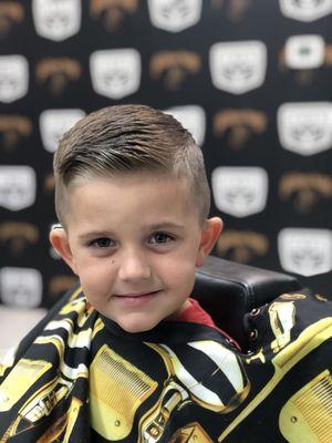 We love kids and we do our best to have them feel comfortable and enjoy their haircuts at an early age. As you can see with this little guy!