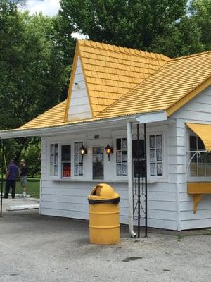 Still, you cannot miss this bright yellow roof and garbage can and shutters