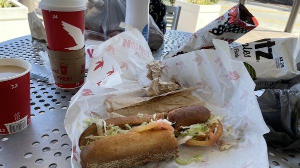 Brisket sub with various chips, and a coffee