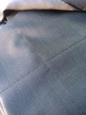 Visible stitching around the outside of the suit trouser leg after hemming