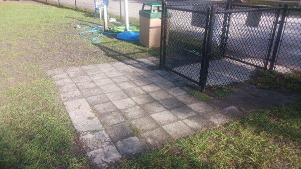 Double gated concrete entryway with brick entry