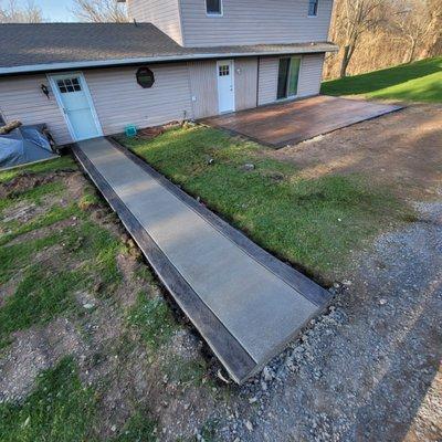 Two-Tone walkway with a stamped wood colored patio in the back