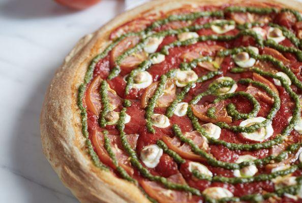 Margherita Pizza - Tomatoes, Fresh Mozzarella and original pizza sauce topped with a swirl of Basil Pesto