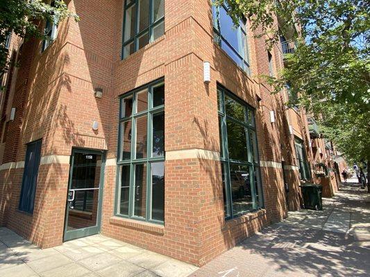 Brick building with tall green paned windows