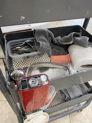 Dirty cart and dirty tray - he dumped the toenails and dirty tools off of the tray and then dumped clean tools onto the same tray.