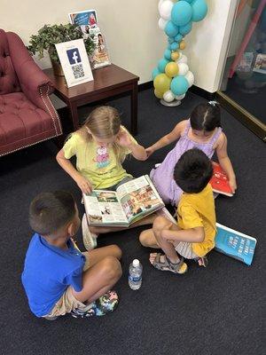 Students form their own reading groups while waiting for class to start.