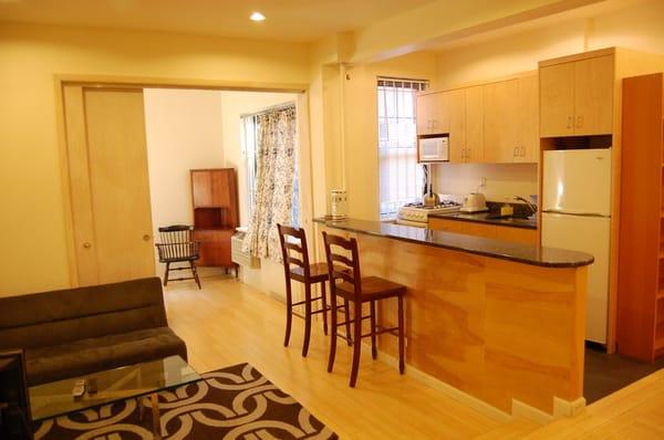 Sample Junior 1 BR apartment with granite kitchen, bamboo floors, recessed lighting, and modern appliances and furniture