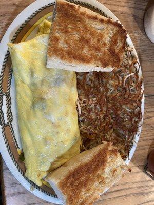 Country omelet with ham, homemade white toast and hash browns.