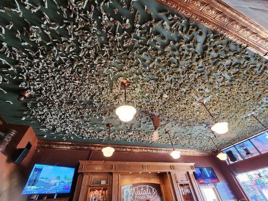 Dollar bills covering the ceiling.