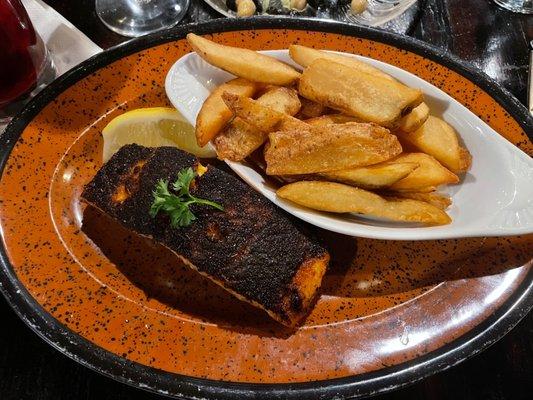 Blackened salmon with steak fries.