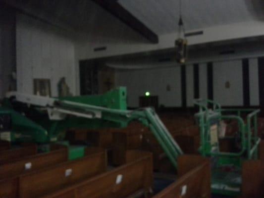 Re wireing all the light fixtures in the church . It was too high for a ladder so we needed to rent a lift