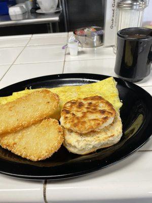 Two egg omelette with hash browns (nice and crispy) with a delicious toasted biscuit.