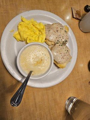 Biscuit and Gravy breakfast with scrambled eggs and grits.