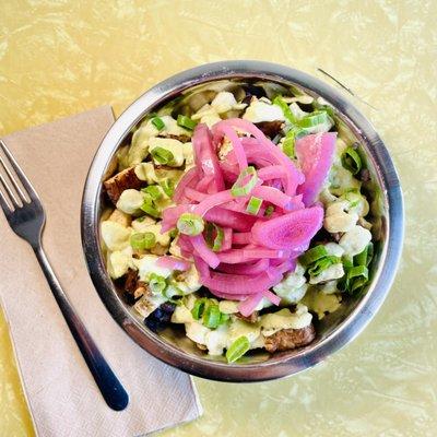 Truffle Hash. Russet potato hash tossed in truffle oil and topped with black beans, tempeh bacon, pickled red onions, chives, and cilantro-g