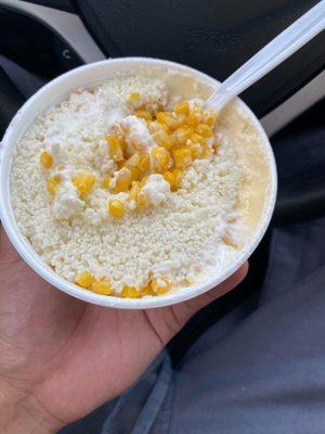 Corn in a cup with crumbled cheese, butter, mayo. Hot sauce not pictured