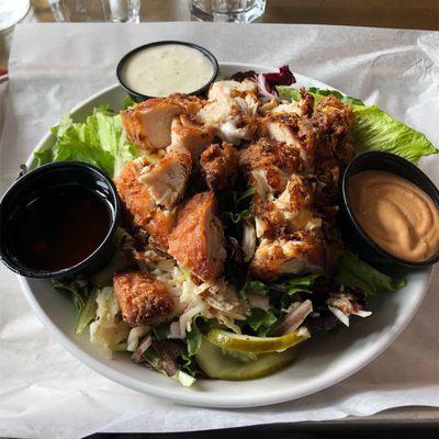 Breaded chicken on salad.