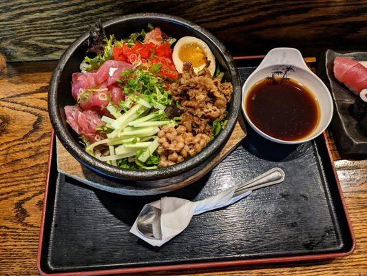 Bukkake Ishiyaki Don. $20. Tuna, natto, beef, cucumber, greens, soft-boiled egg in stone bowl with spicy soy sauce.