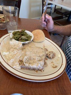 Chicken fried steak already half eaten