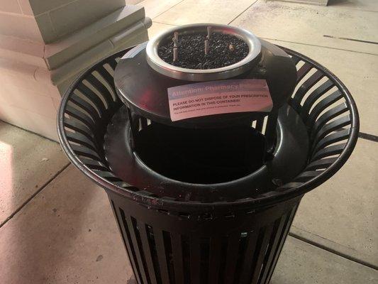 Outdoor trash has a ashtray! They care about the environment