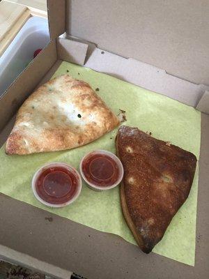 The worst calzone I have ever had.  Strange you would put a burnt calzone in the same box with a properly cooked Stromboli.