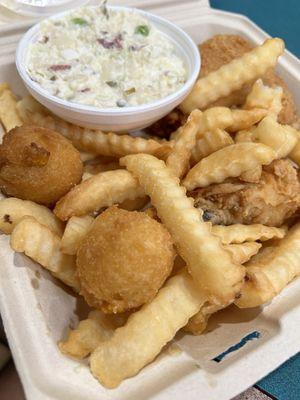 2 piece chicken dinner, with potato salad, French fries, and hush puppies.