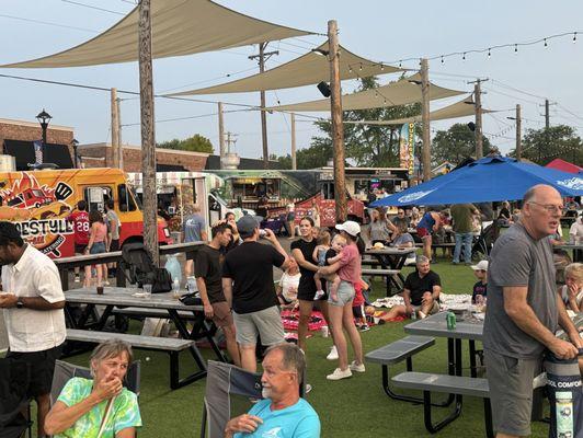 Food trucks and lots of people enjoying.