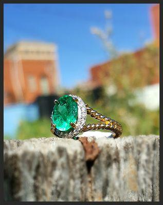 Beautiful yellow gold rope design ring with a gorgeous oval emerald center.