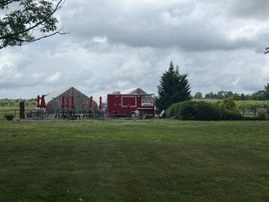 Food truck dining are near vineyards and goat pen