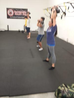 Kettlebell Group class. Double kettlebell Press