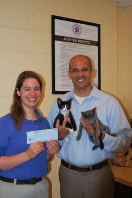 Dr. Cortes presenting a check to CT Humane Society from a Teeth Whitening Fundraiser.