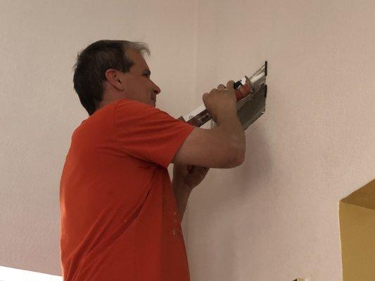 Gary caulking to seal around the air registers.