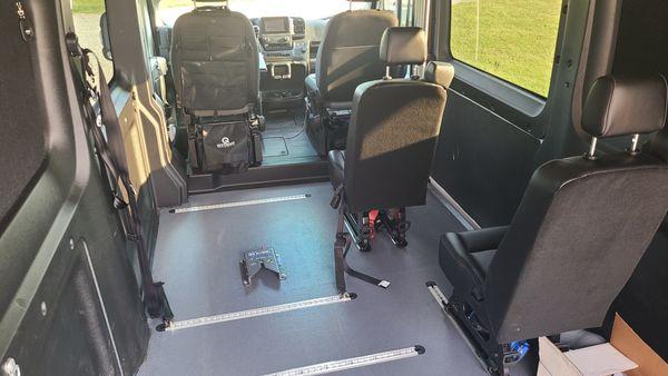 Flooring, wheelchair attachment tracks, EZ Lock system, and additional passenger seating installed.