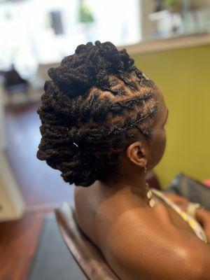 Updo loc style on shoulder length locs.