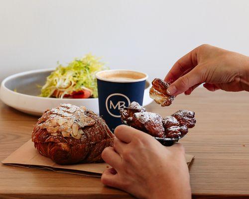 Almond croissant, salmon toast, and latte